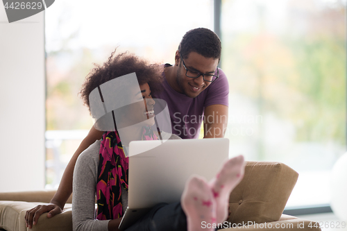 Image of african american couple shopping online