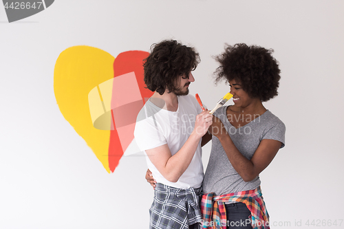 Image of couple with painted heart on wall