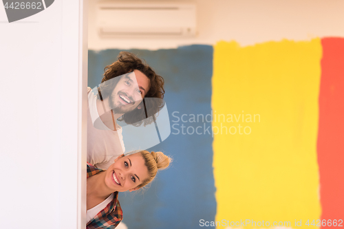 Image of portrait of a couple painting interior wall