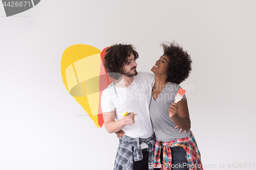 Image of couple with painted heart on wall