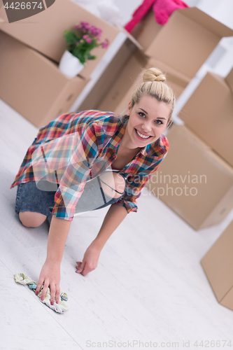 Image of woman cleaning the floor at home