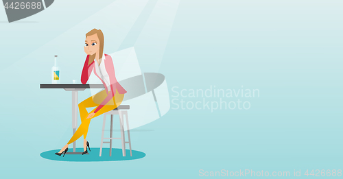 Image of Woman drinking a cocktail in the bar.