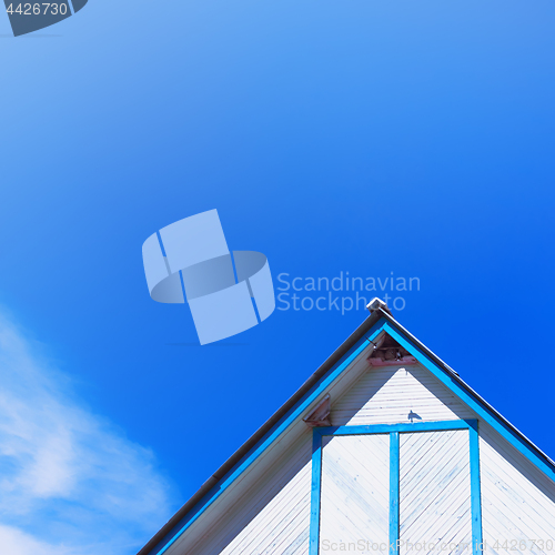 Image of Top Of A Rustic Wooden Building With A Gable Roof Against The Sk