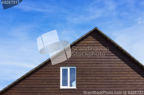 Image of Top Of A Wooden Plank House Against The Sky