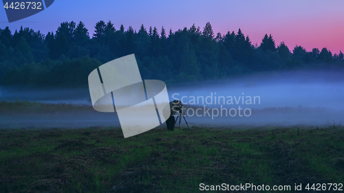 Image of Photographer With A Tripod Shooting The Fog At Dusk