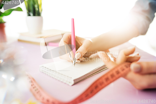 Image of Woman and fruit diet while working on computer in office