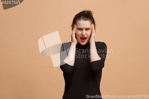 Image of Woman having headache. Isolated over pastel background.