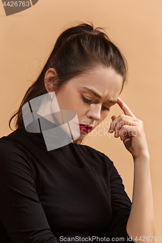 Image of Young serious thoughtful business woman. Doubt concept.