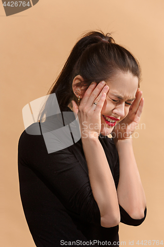 Image of Woman having headache. Isolated over pastel background.