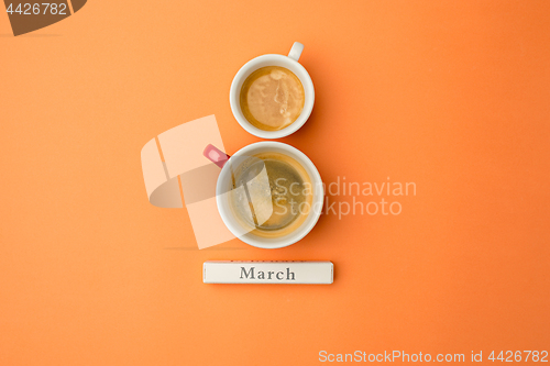 Image of View from above with two cups of coffee with copy space. Background for woman day, 8 March. Orange table.