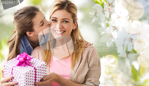 Image of daughter kissing mother and giving her present