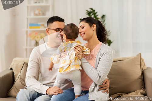 Image of happy family with baby daughter at home