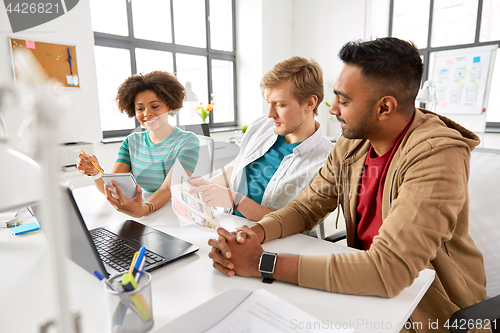 Image of creative office workers discussing user interface