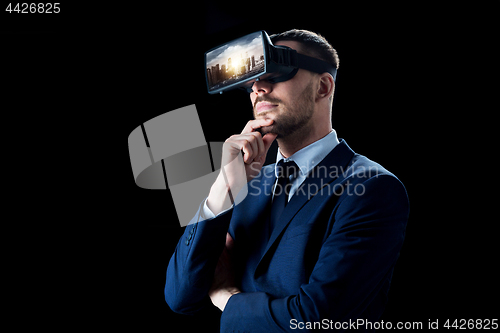 Image of businessman in virtual reality glasses or headset