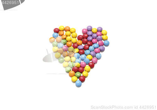 Image of Abstract heart from colored chocolate candy in multicolored glaz