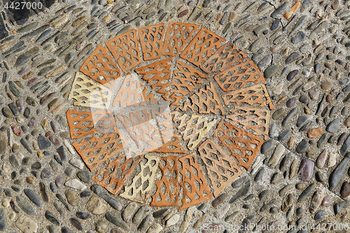 Image of Patterned floor with sea pebbles and red bricks 