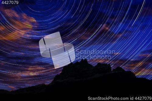 Image of Long exposure image showing Night sky star trails over mountains