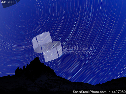 Image of Long exposure image showing Night sky star trails over mountains