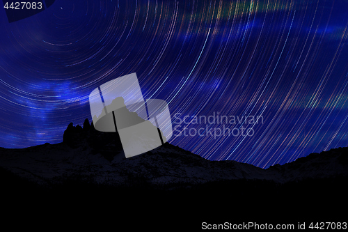 Image of Long exposure image showing Night sky star trails over mountains