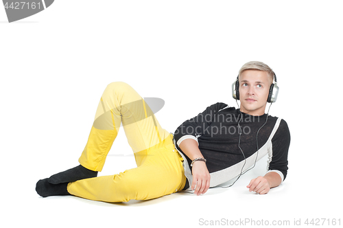 Image of Man in headphones lying down