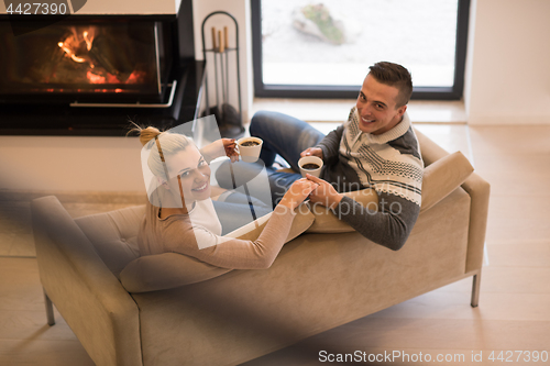 Image of Young couple  in front of fireplace