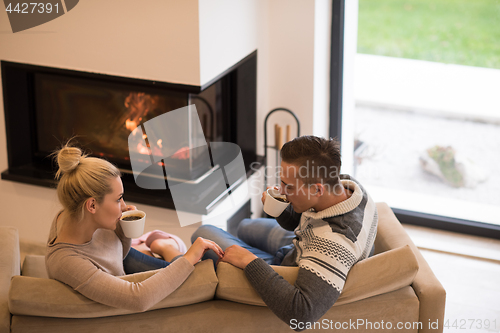 Image of Young couple  in front of fireplace