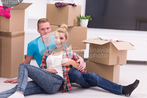 Image of young couple moving  in new house