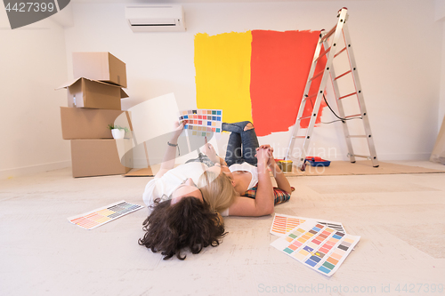 Image of Happy young couple relaxing after painting