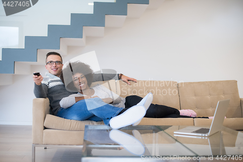 Image of multiethnic couple relaxing at home