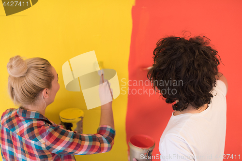 Image of couple painting interior wall