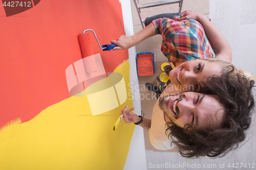 Image of couple painting interior wall