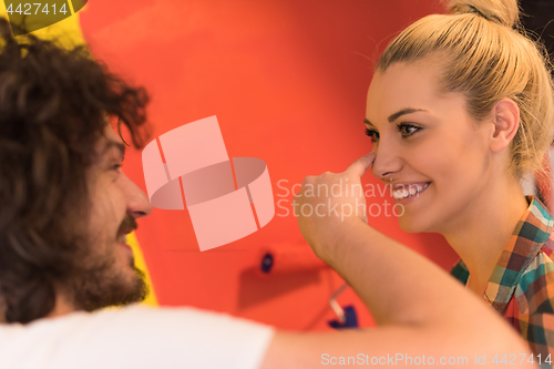 Image of couple painting interior wall