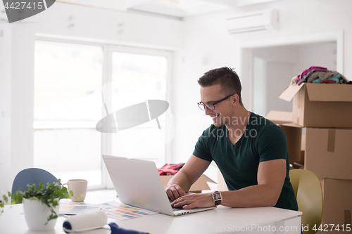 Image of Young man moving in a new home