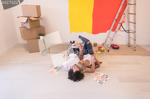 Image of Happy young couple relaxing after painting