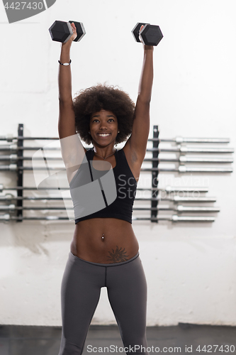 Image of black woman doing bicep curls