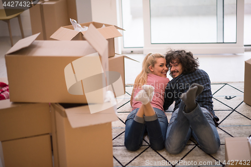 Image of Young couple moving in a new flat