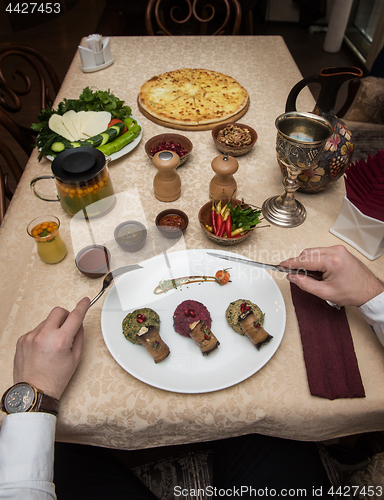 Image of Man eating in georgian restaurant