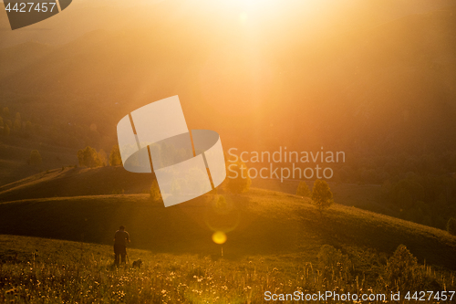 Image of Silhouette of photographer on sunset.