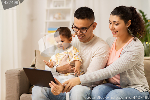 Image of mother, father and baby with tablet pc at home