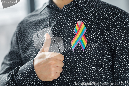 Image of man with gay pride rainbow awareness ribbon