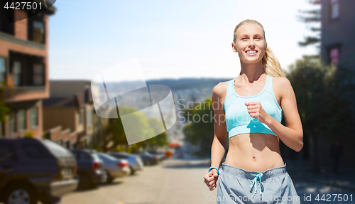 Image of smiling woman running at san francisco city