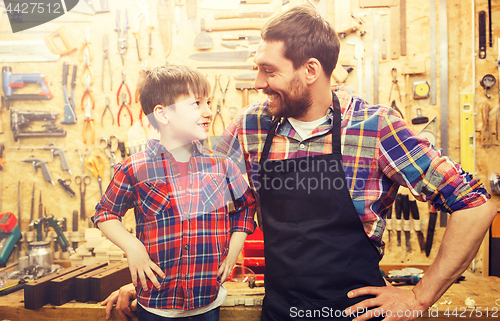 Image of happy father and little son workshop