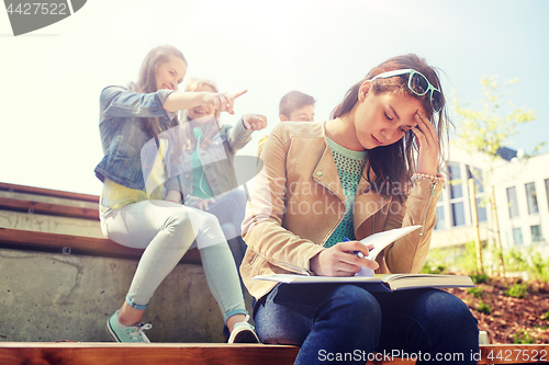 Image of student girl suffering of classmates mockery