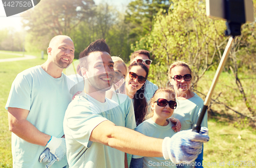 Image of group of volunteers taking smartphone selfie