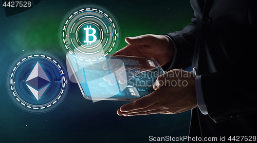 Image of businessman with tablet pc and cryptocurrency