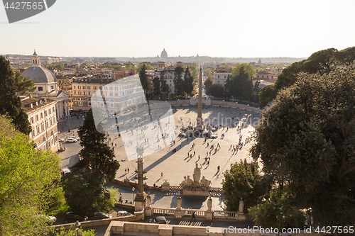 Image of Aerial view of people, sculptures, fountain and churches on Piazza del Popolo in Rome, Italy.