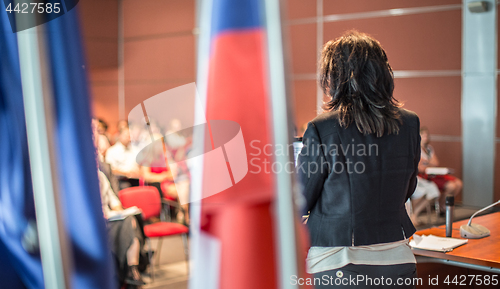 Image of Public speaker giving talk at Business Event.