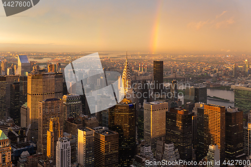 Image of Skyscrapers at midtown New York City with the East River on the background at dramatic after the storm sunset light.