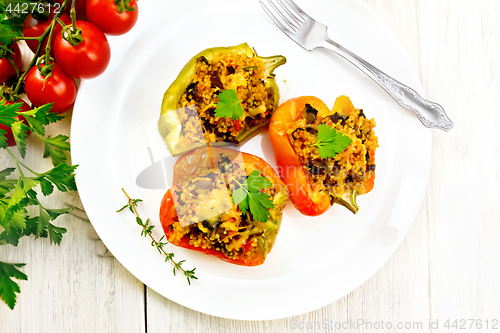 Image of Pepper with mushrooms and couscous in plate on light board