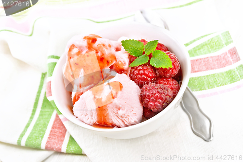 Image of Ice cream crimson with syrup on board